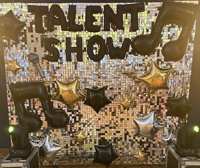 Zdjęcie przedstawia ściankę z wydarzenia Talent Show, o kt&oacute;rym piszę w moim wpisie. Na ściance napisane jest właśnie Talent Show.